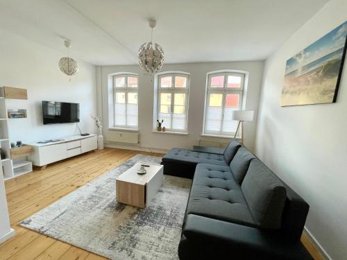 uma sala de estar com um sofá e uma mesa em FeWo Meeres Luft em Wismar