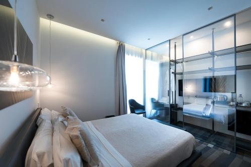 a hotel room with a bed and a bathroom at HOTIDAY Room Collection - Olbia Wallure in Olbia