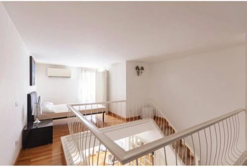 a white room with a staircase and a living room at Apartment luxury Archimede 80 in Rome