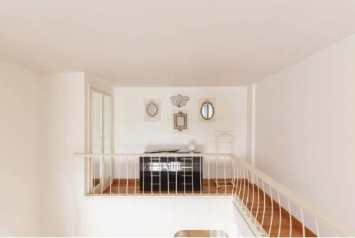 a white room with a staircase with white walls at Apartment luxury Archimede 80 in Rome
