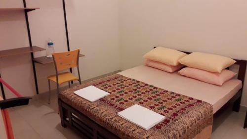 a bedroom with a bed with a chair and a desk at Binara House - Nugegoda, Colombo in Nugegoda