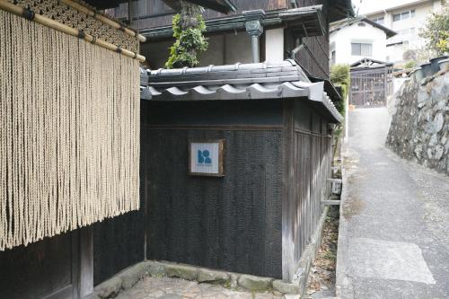 un edificio con un cartello sul lato di DENIM HOUSE BON a Kurashiki