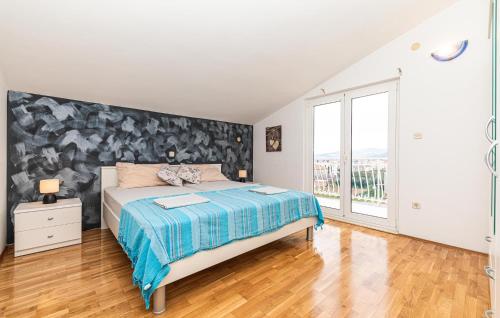 ein Schlafzimmer mit einem Bett und einem großen Fenster in der Unterkunft 3 Bedroom Stunning Apartment In Kastel Luksic in Kaštela
