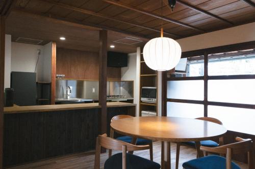 a kitchen and dining room with a table and chairs at DENIM HOUSE BON in Kurashiki