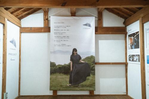 a woman is standing on a large banner in a room at DENIM HOUSE BON in Kurashiki