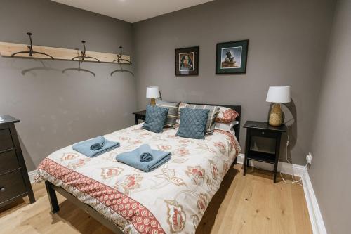 a bedroom with a bed with blue pillows on it at DUNDAS COTTAGE - Beautiful Spacious 3 Bed Cottage in Richmond, North Yorkshire in Richmond