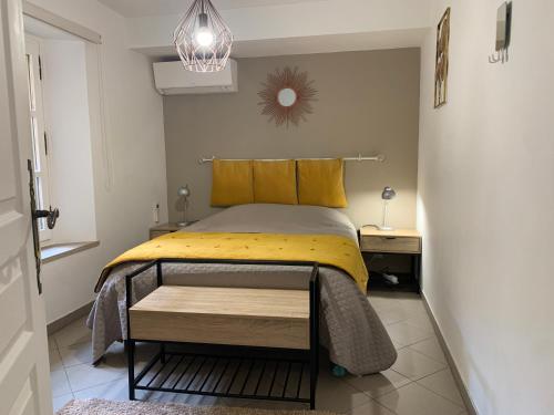 a bedroom with a bed with a yellow comforter at Bel appartement 4 étoiles Centre Historique Toulon in Toulon