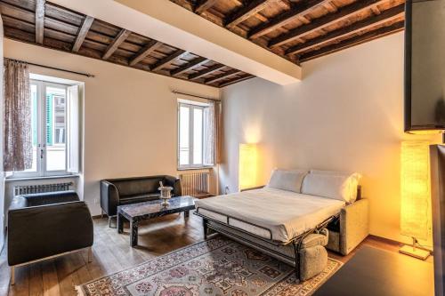 a bedroom with a bed and a couch and a chair at Domus Mondrian Luxury House in Rome