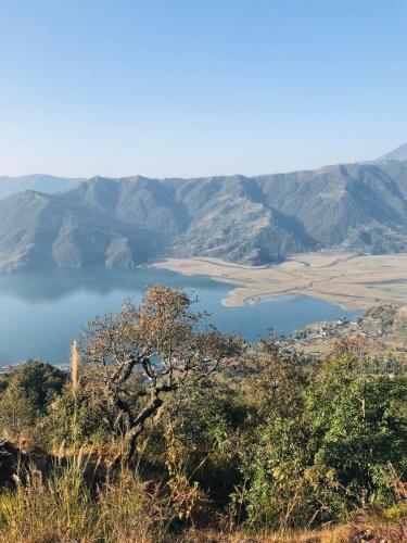 a view of a lake from a mountain at Hom's Homestay Retreat Sarangkot Pokhara in Pokhara