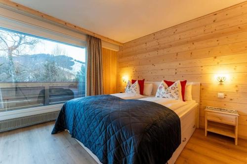 1 dormitorio con cama y ventana grande en Fresh & Simple near Gstaad, en Gstaad