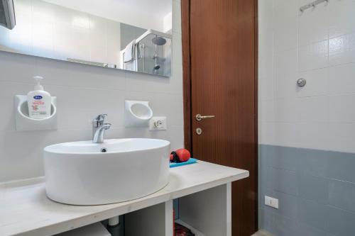 a bathroom with a white sink and a mirror at Moretto 10 - con piscina e WiFi in Sirmione