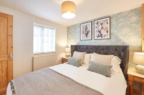 a bedroom with a large bed with two pillows at Little Treasure in Whitby