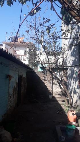 a dark alley with a building in the background at Mud House in Miraj