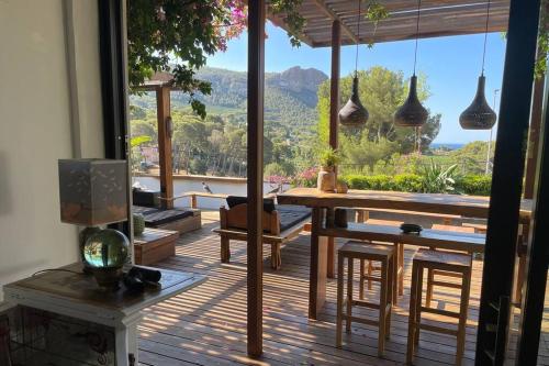 a living room with a table and a large window at Villa Java in Cassis
