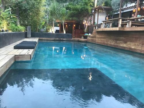a large swimming pool with blue water at Villa Java in Cassis