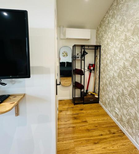 a hallway with a desk and a computer monitor on a wall at Cocon Bourguignon in La Motte-Saint-Jean