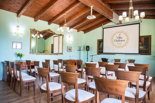 a large room with chairs and a projection screen at Relais Villa Giuliana in Licata