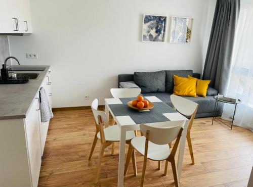 a kitchen and dining room with a table and chairs at Apartament Foka - Rowy in Rowy