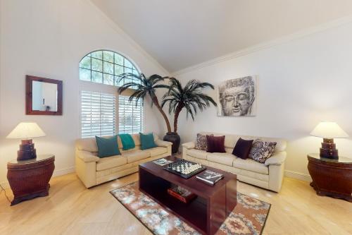 a living room with a couch and a table at Luxury Golfer's Sanctuary in Indio