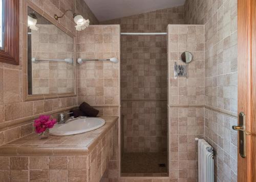 a bathroom with a sink and a shower at Apartment Bougaivillea by Finca Es Torrent in Sa Ràpita