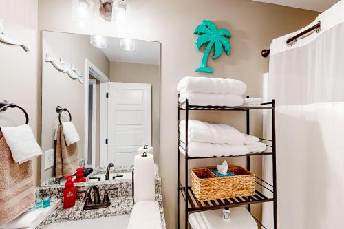 a bathroom with a sink and a mirror and towels at Old Woodland Station in Clarksville