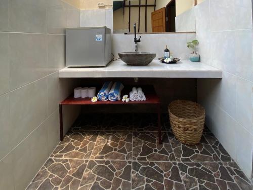 a bathroom with a sink and a counter with a counter at Mustika Ocean Lodge in Gili Islands