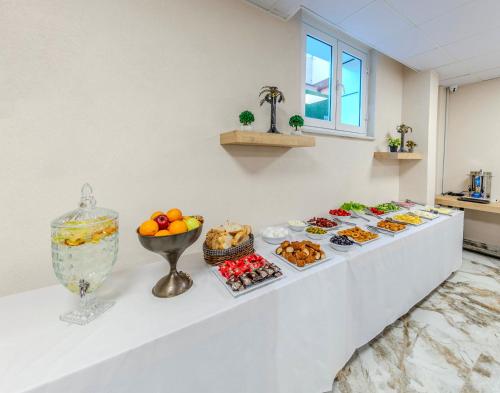 a buffet line with desserts and food on it at The Business Class Hotel in Istanbul