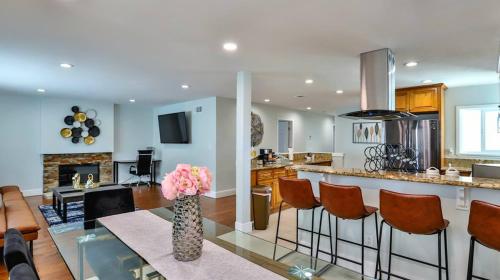 a kitchen and living room with a table and chairs at H&H Modern Lux 4BD 1 King Suite 3 Queen SoCal Disney in Westminster