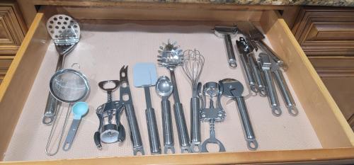a drawer filled with lots of kitchen utensils at H&H Modern Lux 4BD 1 King Suite 3 Queen SoCal Disney in Westminster
