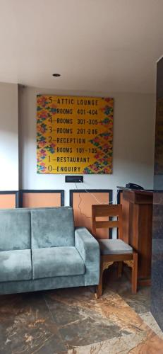 a living room with a blue couch and a chair at Gakhil Boutique Hotel in Darjeeling