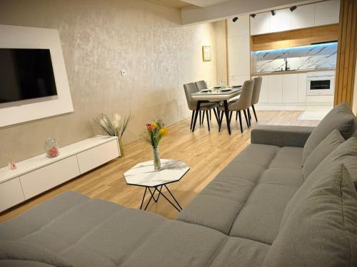 a living room with a couch and a table at Cozy and Stylish Apartament in Stara Zagora