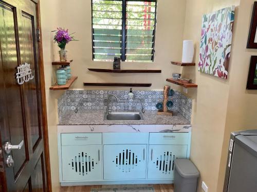 a bathroom with a sink and a toilet at Aguanga Cabin at Threesome Cafe in Cebu City