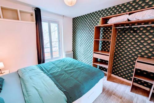 a bedroom with a bed and a shelf of wine bottles at 2P agréable et spacieux proche du Stade de France! in Saint-Denis