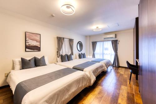 a hotel room with two beds and a window at soleil Universal Fukushima Noda -vacation rental- in Osaka