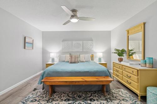 a bedroom with a bed and a ceiling fan at Sea Coast Gardens II 115 in New Smyrna Beach