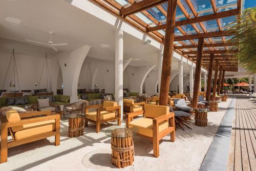 a large room with chairs and tables and a building at OBLU SELECT Sangeli - Premium All Inclusive with Free Transfers in North Male Atoll