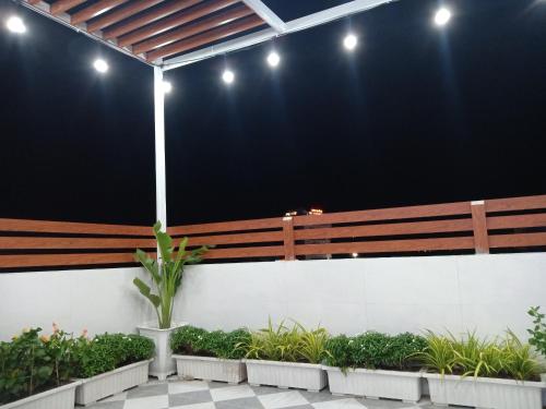 a wooden bench in a building with plants at T&T Luxury Hotel in Quy Nhon