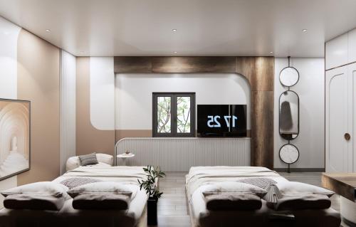 a room with three beds and a window at T&T Luxury Hotel in Quy Nhon