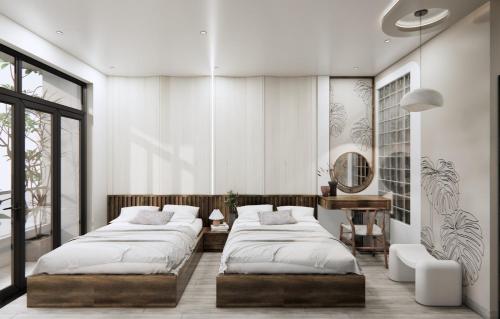 two beds in a bedroom with white walls and windows at T&T Luxury Hotel in Quy Nhon