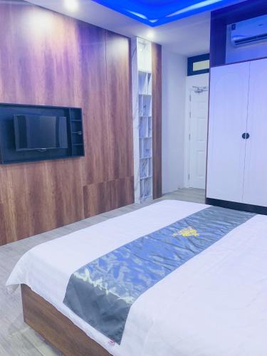 a bedroom with a bed and a flat screen tv at T&T Luxury Hotel in Quy Nhon