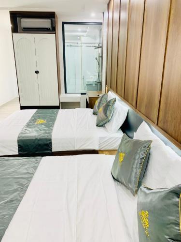 two twin beds in a room with a window at T&T Luxury Hotel in Quy Nhon