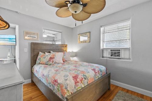 a bedroom with a bed and a ceiling fan at Flagler Suites 3 in New Smyrna Beach