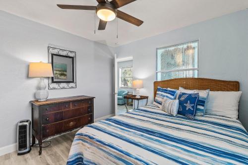 a bedroom with a bed and a ceiling fan at Flagler Suites 2 in New Smyrna Beach