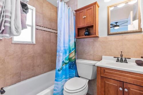 a bathroom with a toilet and a sink at Flagler Suites 2 in New Smyrna Beach