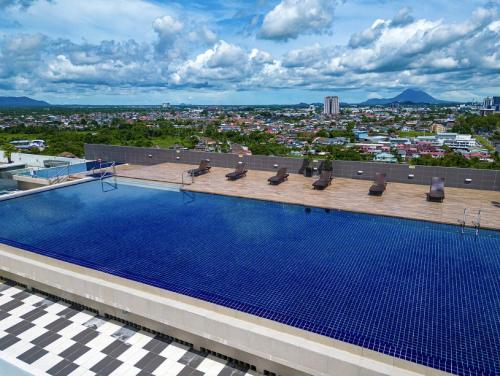 a swimming pool on the roof of a building with a view at APARTMENTS @ PODIUM, KUCHING in Kuching