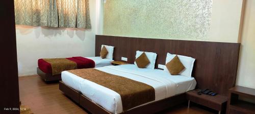 a hotel room with two beds in a room at The Lotus Boutique Hotel in Chikmagalūr