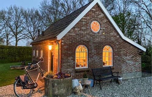 a small brick house with a bike parked in front of it at Kruudhuuske in Aalten