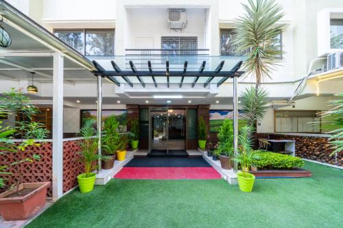 an office building with a hallway with plants at Lords Midtown Suites Bangalore in Bengaluru
