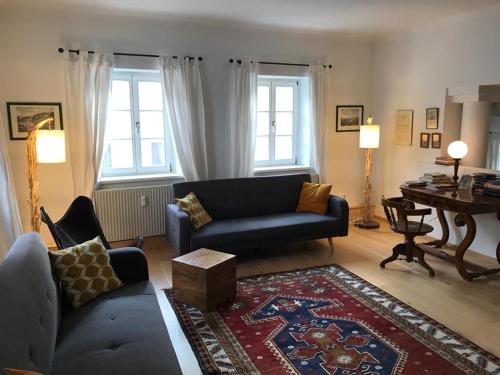 a living room with a couch and a table at Schön wohnen beim Stift in Melk