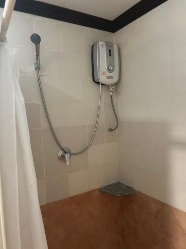 a shower in a bathroom with a shower curtain at Fanari Khaolak Resort - Courtyard SHA Extra Plus in Khao Lak